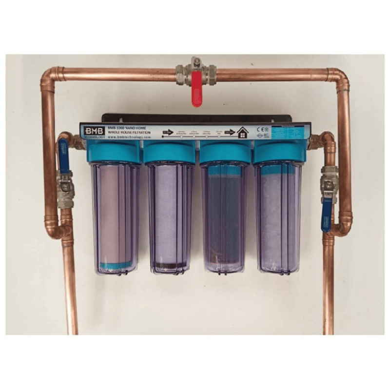a whole house filtration system installed with four filters and copper piping