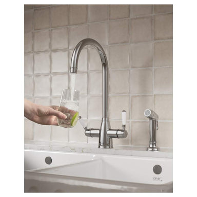 clearwater 4 in 1 tap pouring water into a glass with a hose next to it