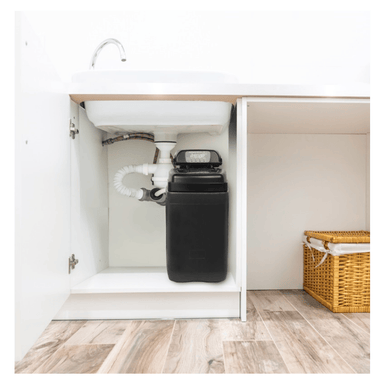 Ecosoft water softener installed and connected underneath a sink