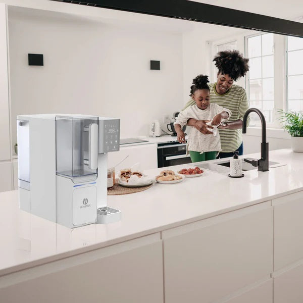 A countertop dispenser on a work surface with a mother and child