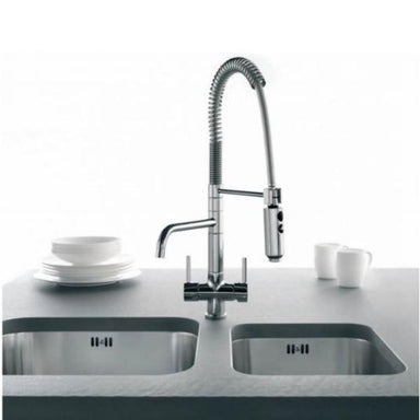 Osmio three way tap installed in a kitchen with two sinks and crockery in the background