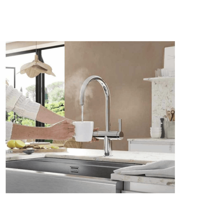 a chrome tap produces boiling water into a cup