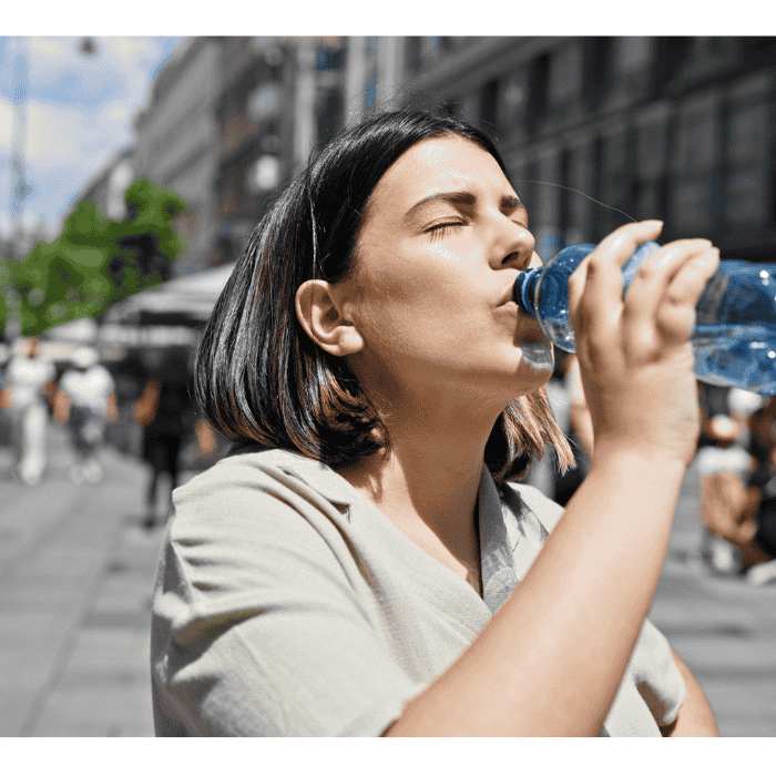 A woman drinking bottled water