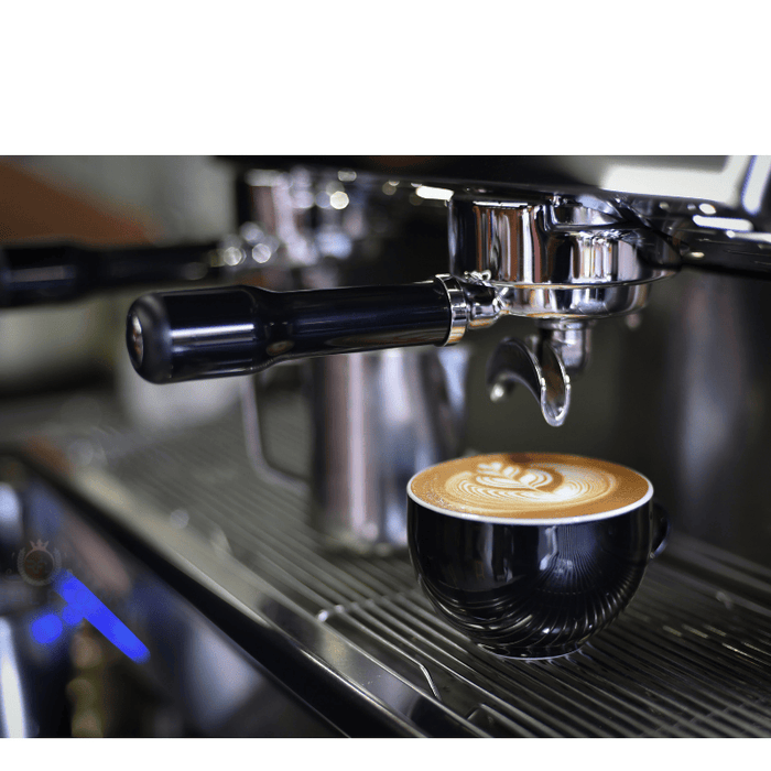 A coffee cup under a coffee machine