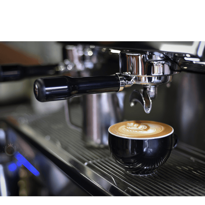 A coffee cup under a coffee machine