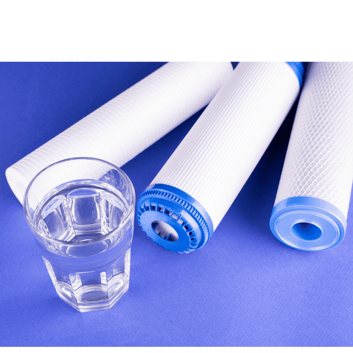 Three water filters and a glass of water