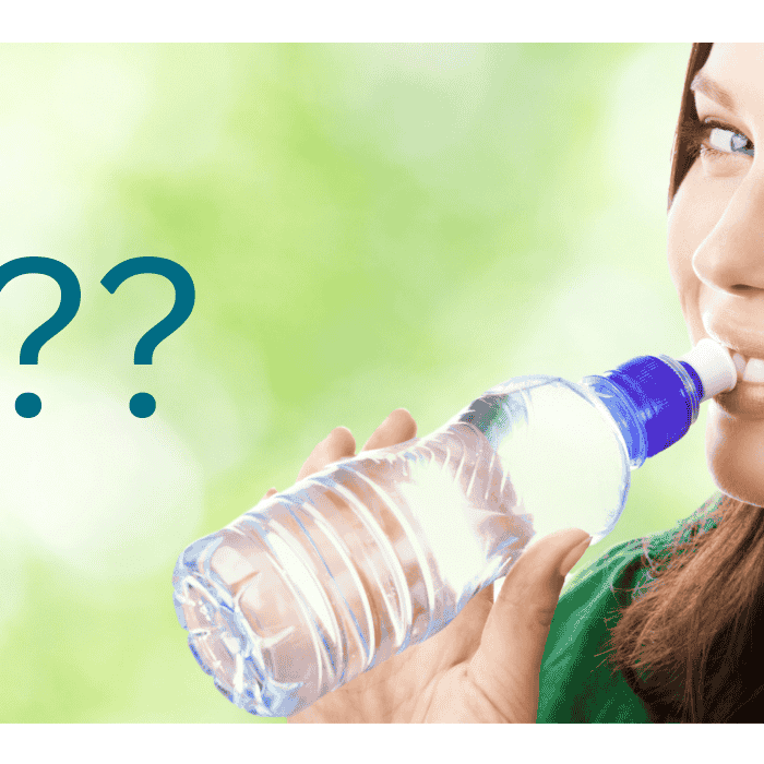 A woman drinking water from a bottle