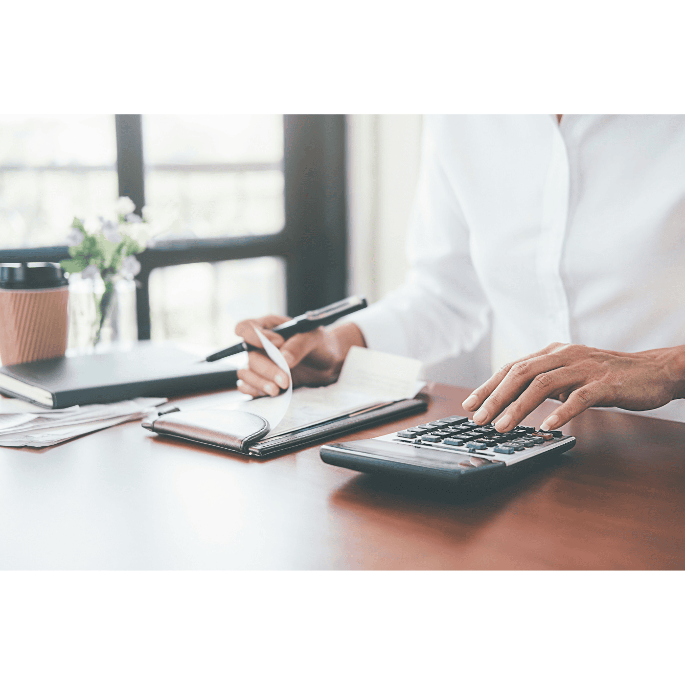 A man with a calculator pen and pad