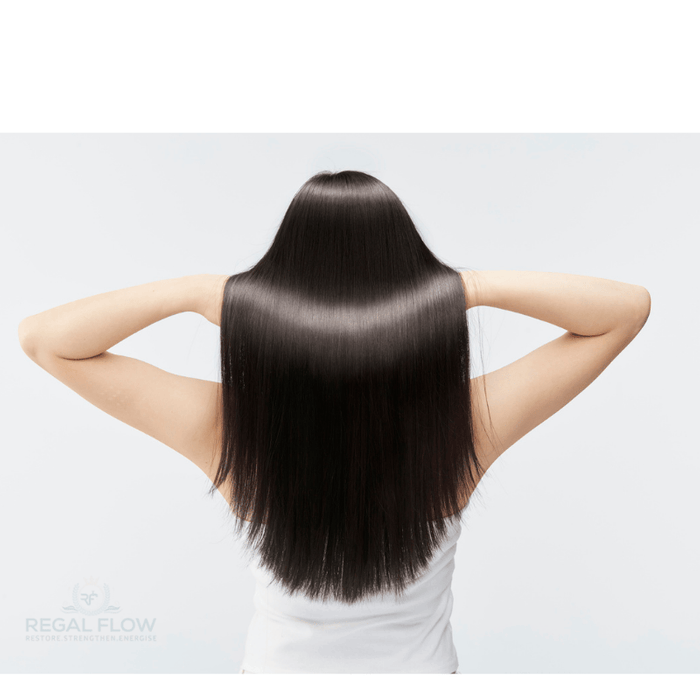 a woman with her hands in her black hair with regal flow logo