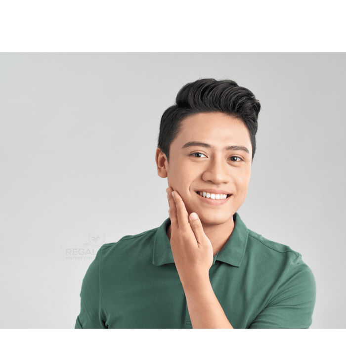 a man with his hand to his right cheek