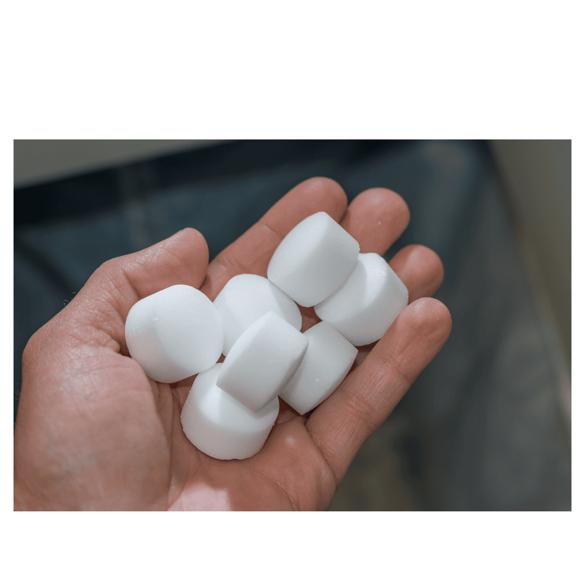 Water softener tablets in a hand