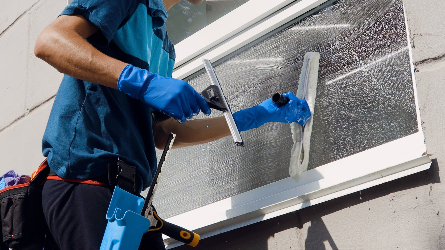 A window cleaner cleaning windows
