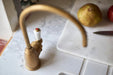 Aged brass instant hot water tap with white lever handle on marble countertop