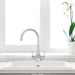 Verona SQ chrome 3-way tap installed on white sink beneath window for filtered water use