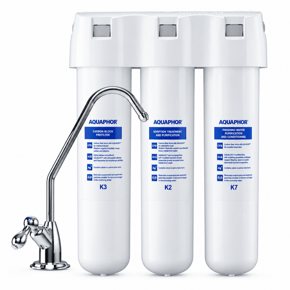 AquaPhor under sink water filter system with three white filter cartridges labeled K3, K2, and K7, a curved chrome faucet spout, and a three-hole mounting cap on a white background.