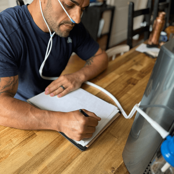 Man inhaling hydrogen therapy gas using Hydrogen Inhaler at home