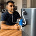 Man using a home oxygen concentrator in a kitchen.