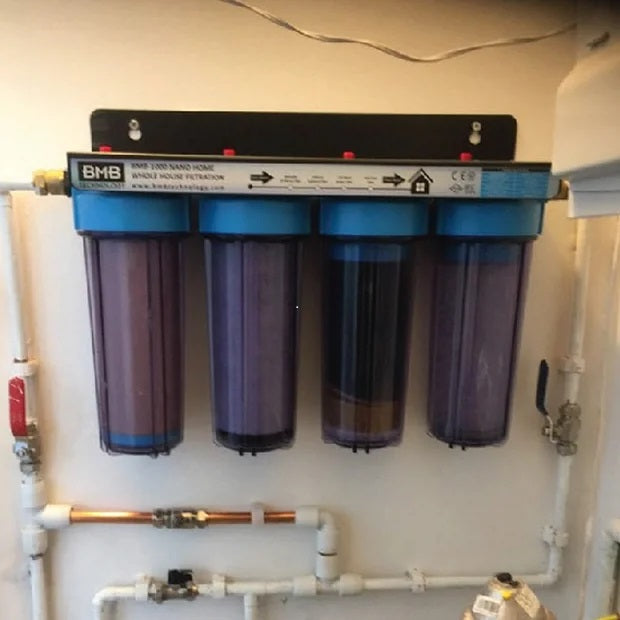 whole house water filter installed on wall 
