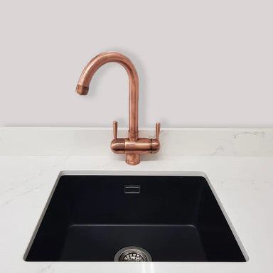 A Copper Three Way Triflow Tap installed with a sink in front