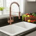 Kitchen sink with copper faucet and fruit on the counter