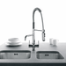 Chrome three way filter tap with pull out hose spray installed over a sink with coffee cups and plates
