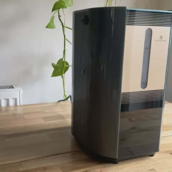 Person using Hydrogen Inhaler while writing at a desk for wellness routine