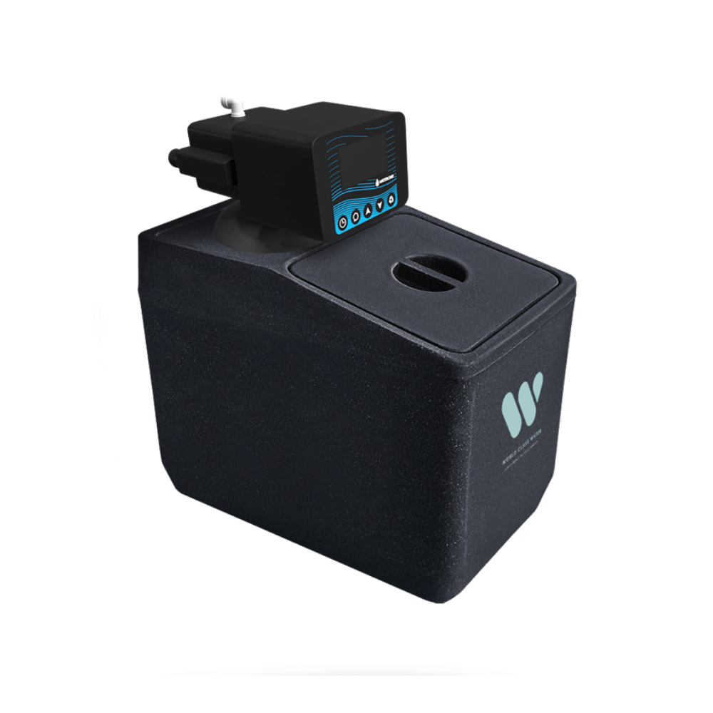 A black residential water softenerk with a top lid and a small black electronic control unit mounted on top, featuring a blue display screen and four circular ports. photographed on a clean white background.
