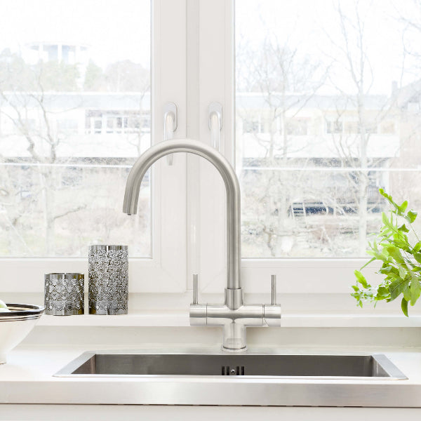 Verona 2 Lever brushed steel 3-way tap installed on modern kitchen sink beneath window